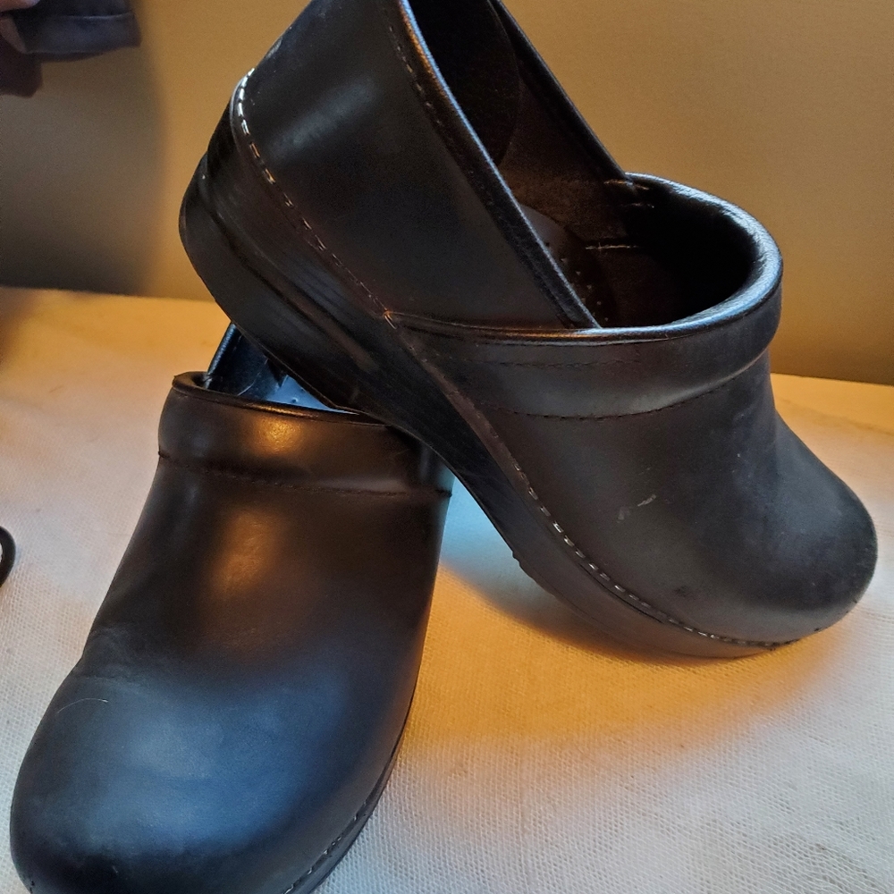 Women's black Dansko clogs.